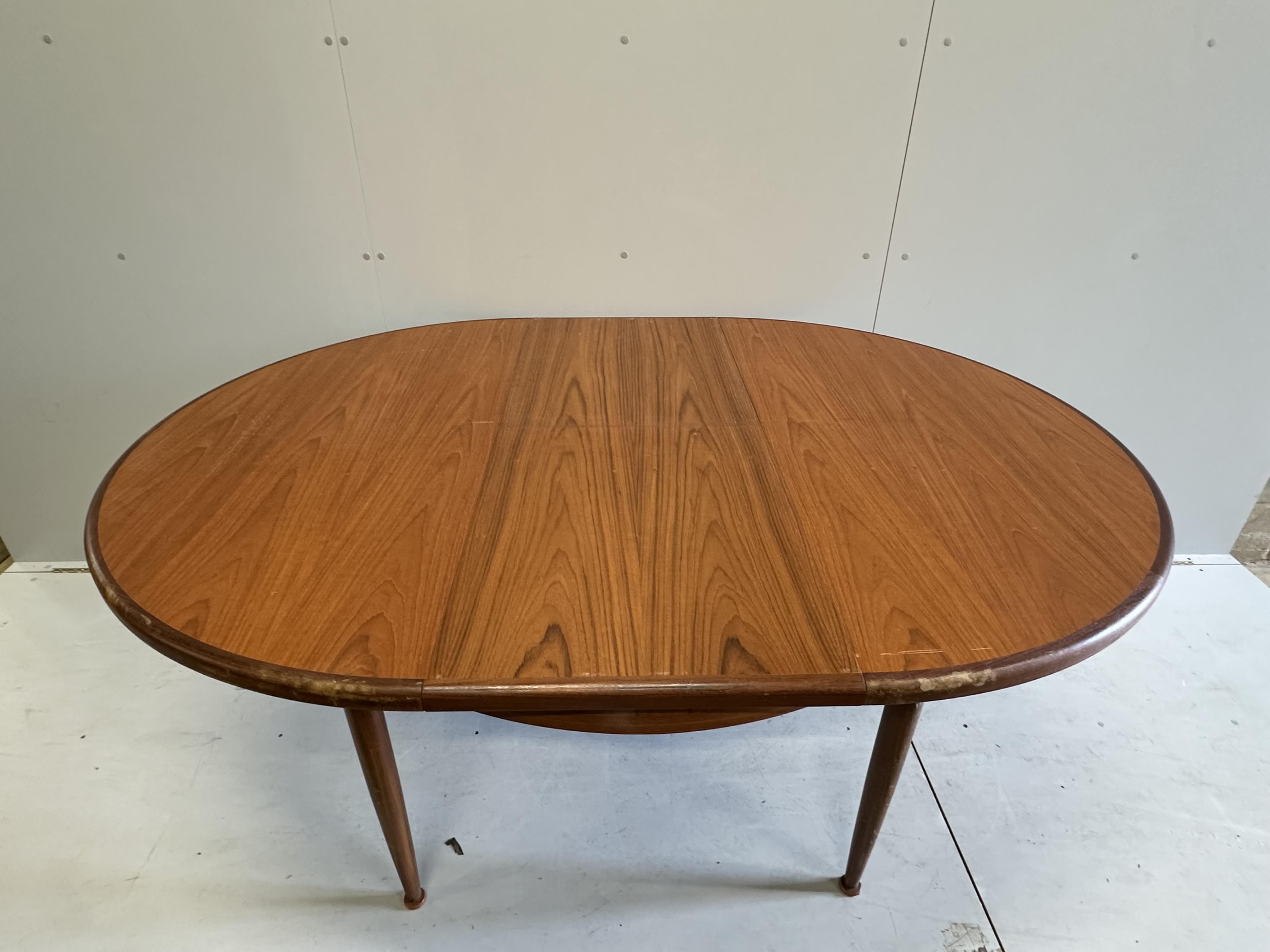 A G Plan circular teak extending dining table, diameter 120cm, height 74cm, and six chairs. Condition - fair